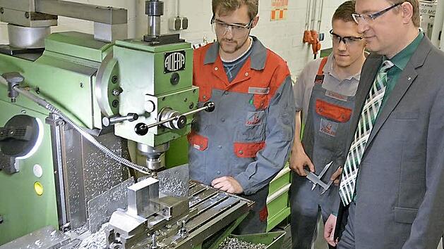 In der Lehrwerkstatt lernen Matthias H&ouml;h (links) und Nico Beyerlein die Grundlagen der Metallbearbeitung. Stefan Zaigler (rechts) ist stolz auf seine Azubis. Foto: Dagmar Besand
