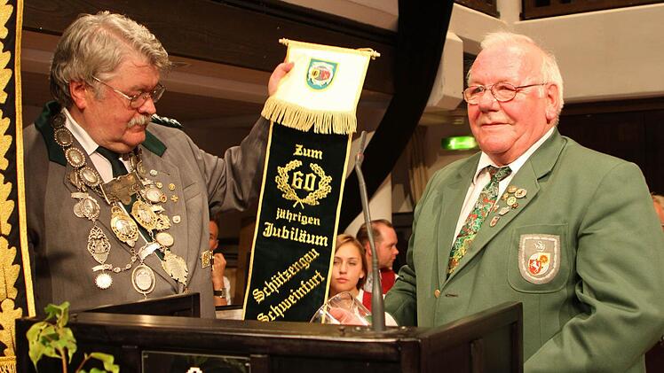 Von den Schützen aus Dortmund-Schwerte überreichte Siegfried Redker ein Fahnenband an Dieter Koch (links).