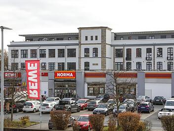 Die ehemalige Spinnerei (im Hintergrund) wurde in Wohnungen umgebaut. Neben den Supermarkt Rewe und den Discounter soll der Drogeriemarkt Rossmann einziehen.  Foto: Barbara Herbst