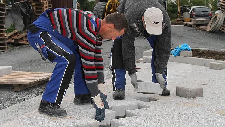 Lucan Comah und Christian Vasile Farcas pflastern den neuen Parkplatz der Fachklinik Stadtsteinach. Die Arbeiter aus Rumänien sind in ganz Deutschland tätig. Fotos: Sonja Adam