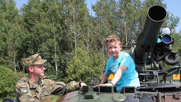 Der kleine Luca aus Oberwildflecken will unbedingt den Waffenträger Wiesel TOW 1 A1 erkunden. Feldwebel Denis Hans erklärt dem Sechsjährigen alles ganz genau.