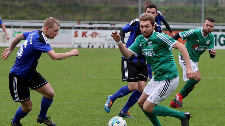 Andre Karmann (rechts vorne) versucht, an den Ball zu kommen.  Links Gästespieler Florian Reich und rechts Dominik Rippstein.