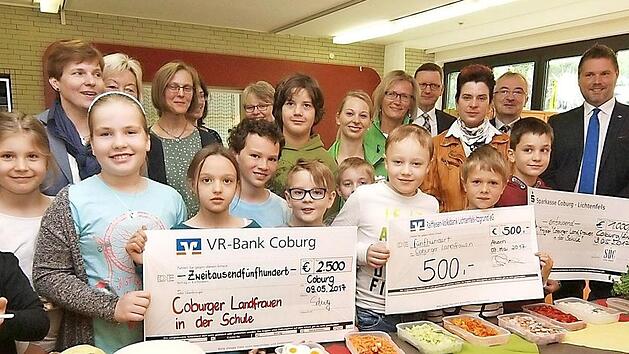 Viele gute Zutaten f&uuml;r ein gesundes Schulfr&uuml;hst&uuml;ck haben die Coburger Landfrauen vorbereitet. Das Projekt "Coburger Landfrauen in der Schule" finanzieren in diesem Jahr die VR-Bank Coburg, Sparkasse Coburg-Lichtenfels, S&Uuml;C, Raiffeisen-Volksbank Lichtenfels-Itzgrund sowie der Kreisverband Coburg des Bayerischen Gemeindetags und der Ring junger Landfrauen. Die symbolischen Spendenschecks brachten die Vertreter der Banken und der S&Uuml;C in die Ahorner Grundschule mit. Foto: privat