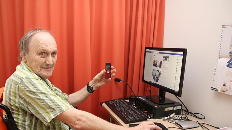 Holger Hühnert wäre gerne mobiler unterwegs und hätte sein altes Handy schon lange gegen ein Smartphone ausgetauscht - wenn es im Seniorenwohnpark Rosengarten WLAN gäbe. Über seinen Computer geht er umständlich mit einem Internetstick online. Foto: Jürgen Gärtner