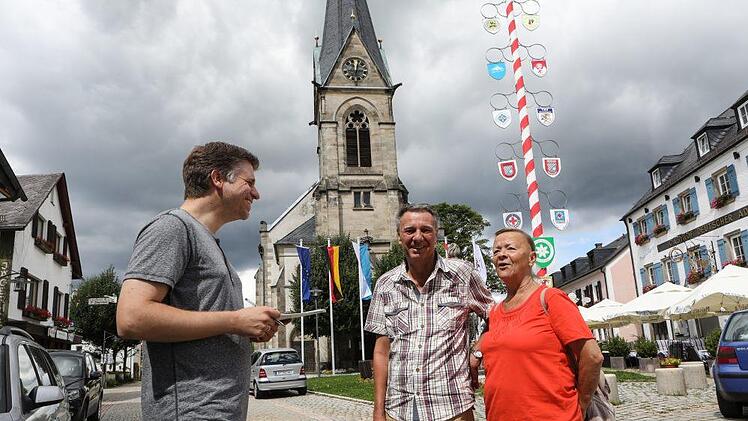 Reporter Matthias Litzlfelder unterhält sich am Dorfplatz mit dem Ehepaar Bochmann. Foto: Barbara Herbst