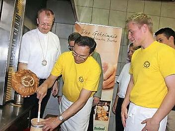 Natürlich gab es auch Geschenke. Hier mussten Georg Oesterlein und Sebastian Zeis zum ersten Mal mit dem Butterkrug zum Einsatz. Mit im Bild: Regionaldekan Thomas Teuchgräber (links). Foto: Veronika Schadeck