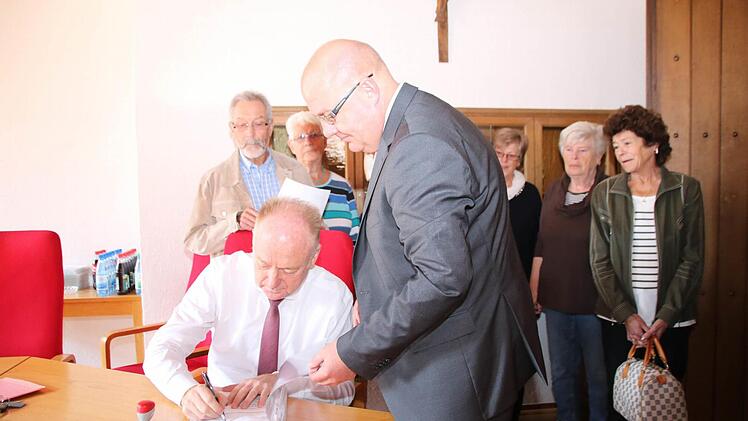 Bürgermeister Helmut Blank bestätigt mit seiner Unterschrift den Eingang des Bürgerbegehrens. Zuvor hatte geschäftsleitender Beamter Stefan Bierdimpfl (rechts vorne) die Unterschriftenlisten gezählt. Fotos: Heike Beudert