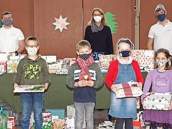 Vier Kinder aus der Klasse D1A der St.-Katharina-Schule nahmen ihre Geschenke von den beiden Siemens-Healthineers-Mitarbeitern Michael Kaden (links) und Benedikt Debel (rechts) im Beisein der Schulleiterin Ute Donhauser (Mitte) entgegen. Foto: Alfred Thieret