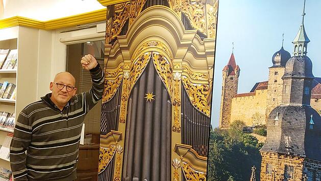 Zwischen Orgel, Prospekten und der Veste: Horst Graf in der umgestalteten Tourist-Info in der Herrngasse. Die großen Bilder sollen neugierig machen auf Coburg. Foto: Simone Bastian