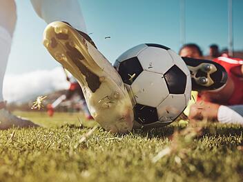 Soccer, soccer ball and man slide tackle during match, training or competition outdoors. Football, sports and football players on grass field for workout, fitness or exercise game on football pitch Fußball, Fußball und Mann beim Grätschen während eines Spiels, Trainings oder Wettkampfs im Freien. Fußball, Sport und Fußballspieler auf Rasenplatz beim Training, Fitness oder Spiel auf dem Fußballplatz. Fußball, Fußballplatz, Kreisliga, Amateurfußball