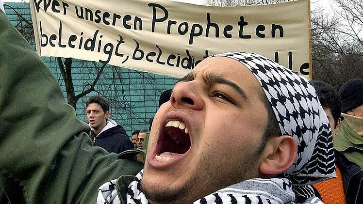 Das Archivbild zeigt einen jungen Muslim, der im Jahr 2006 in Berlin gegen die Mohammed-Karikaturen demonstriert. Fotos: S. Pilick /dpa/Ronald Rinklef