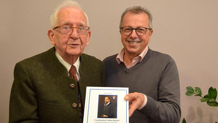 Kreisheimatpfleger Werner Eberth überreichte dem stellvertretenden Kissinger Landrat Emil Müller eines der ersten Exemplare seines jüngsten Buches mit dem Titel " Fürstbischof Julius Echter und seine Bauinschriften".  Foto: Peter Rauch