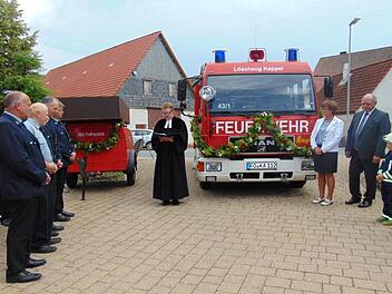 Pfarrer Jacek Kikut segnet das neue Feuerwehrauto und den Zeltanhänger (l.). Foto: Petra Malbrich