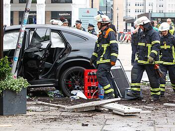 Auto fährt in Menschengruppe in Hamburger Sparkasse