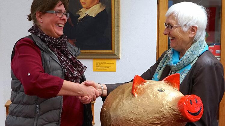Die Leiterin der Musikschule, Daniela Wagner, freute sich über das mit 900 Euro gemästete goldene Sparschwein, das ihr Jubilarin Sieglinde Leiding überreichte. Foto: Musikschule