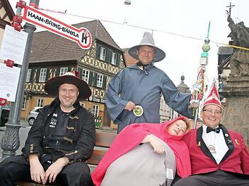 Gag zum 11.11. auf dem Staffelsteiner Marktplatz: Der Staffelsteiner Karnevals-Klub (SKK) eröffnet sein "Haam-Bring-Bänkla". Unter der Aufsicht von Erstem Präsidenten Matthias Graß haben hier (vorn v. l.) Jo Riemer, Margit Schnapp und Michael Hess Platz genommen. Foto: Matthias Einwag