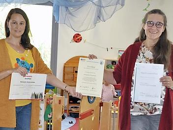 Michaela Steinrichter und Marion Schleicher von der Kindertagesstätte "Pfiffikus"in Pfarrweisach haben sich nebenberuflich weitergebildet und Zertifikate erhalten. Besonders stolz sind sie auf die Auszeichnung der VIVA-Studie der Otto-Friedrich-Universität Bamberg, die sie gemeinsam in ihren Händen halten.  Foto: Simon Albrecht
