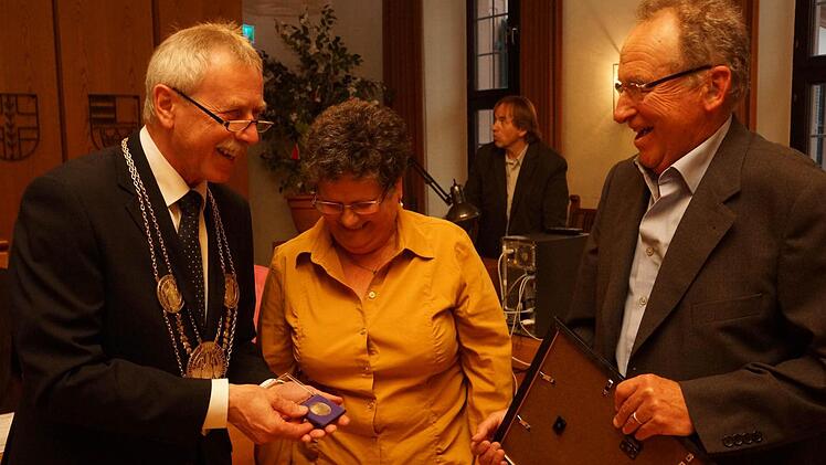 Bürgermeister Ernst Stross (links) zeigt Cornelia und Michael Mence die Stadtplakette. Foto: Arkadius Guzy