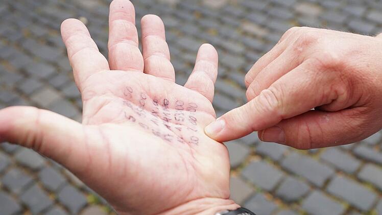 Peter Frankenstein hat sich die gewünschten Zwischenzeiten auf die Handfläche notiert. Foto: Sarah Dann