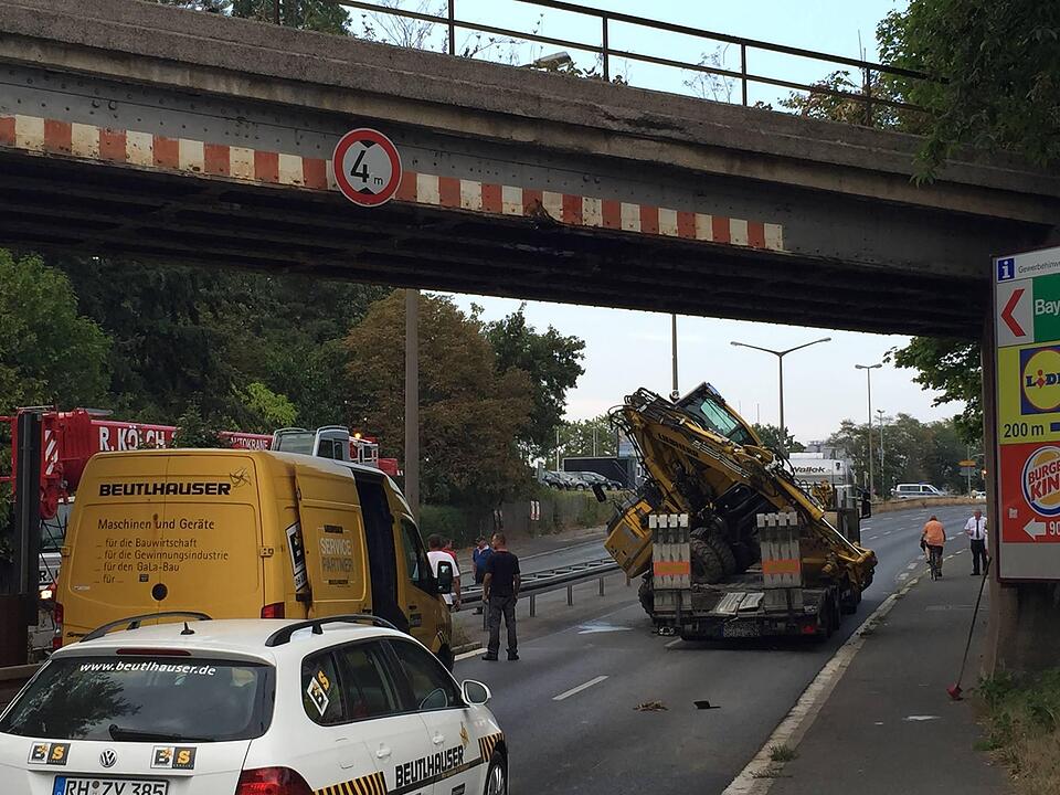 Am Montagnachmittag (10.08.2015) ereignete sich ein kurioser Unfall auf der Rothenburger Strasse in Oberasbach. Ein Lkw-Fahrer hatte offensichtlich die Höhe seines aufgeladenen Baggers unterschätzt. Als das Gespann unter einer Brücke hindurchfahren wollte, prallte der Ausleger der Baumaschine gegen das Bauwerk, wodurch der Bagger seitlich vom Lastwagen stürzte. Erst durch einen Kran konnte die havarierte Maschine wieder aufgeladen werden. Währenddessen musste die Straße komplett gesperrt werden.