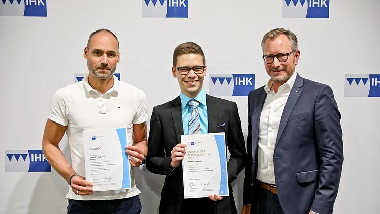 Ausbilder Mathias Köhne (links) und der Vizepräsident IHK Bayreuth, Jörg Lichtenegger (rechts), gratulieren den  bayerischem Landesbesten Samuel Schneider. Foto: Thorsten Ochs