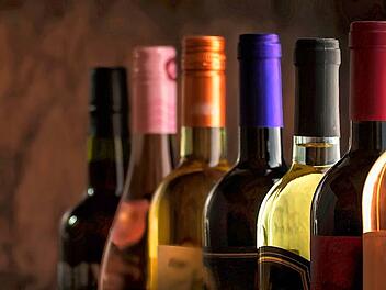 Wine bottles collection row in wine cellar, winery basement, bar