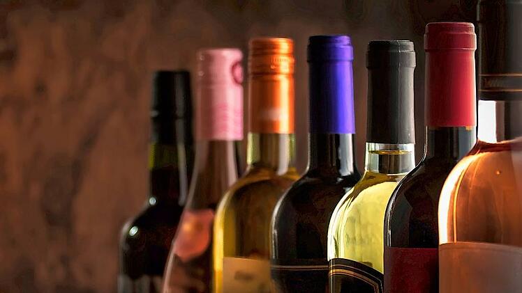 Wine bottles collection row in wine cellar, winery basement, bar