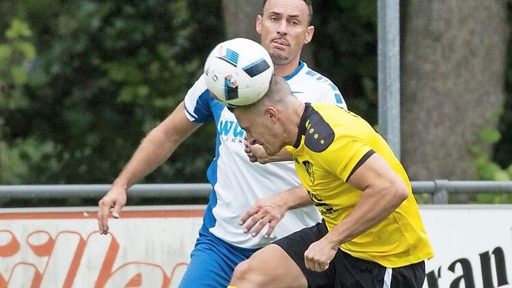 SV Fischbach - TSV Küps: Gästespieler Andre Paura (gelbes Trikot) hat aufgepasst und köpft den Ball vor dem zweifachen Torschützen Rolf Voitländer weg. Foto: Heinrich Weiß