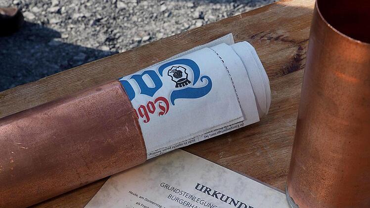 Eine Tageszeitung, Münzen sowie eine Urkunde mit Informationen über das Bürgerhaus am Wolfgangsee enthält der Grundstein. Foto: Christoph Winter