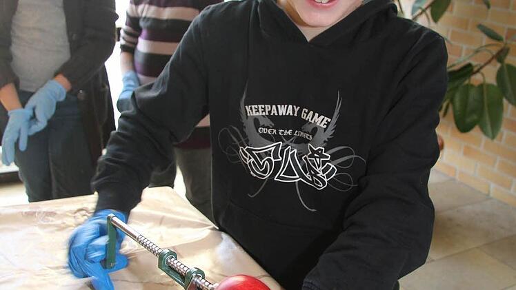 Hannes Lanzendorfer (10) hat den Dreh raus: Mit einer Schlange schält er die Äpfel mit der Drehmaschine ab - und schneidet sie auch gleich in Scheiben.