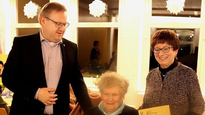 Pfarrer Thomas Ringer und Maria Zahnleiter ehren Lina Papp. Foto: Johanna Blum