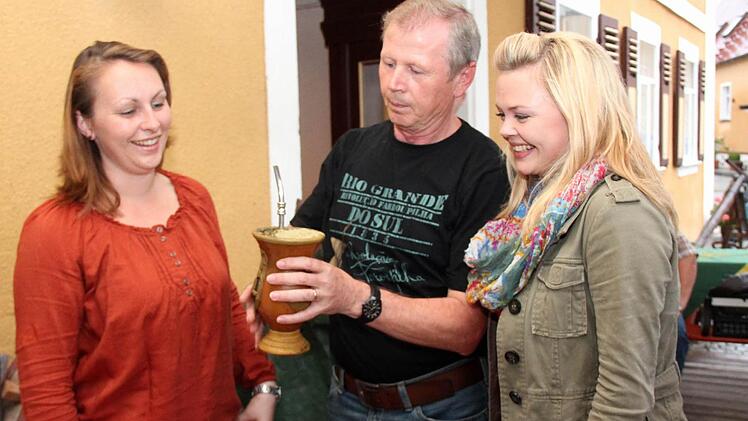Karl Kaiser (Mitte) erklärt den Damen vom Orga-Team Christine Popp (links) und Cornelia Panten, wie man Chimarrão, einen speziellen Matetee, zubereitet.