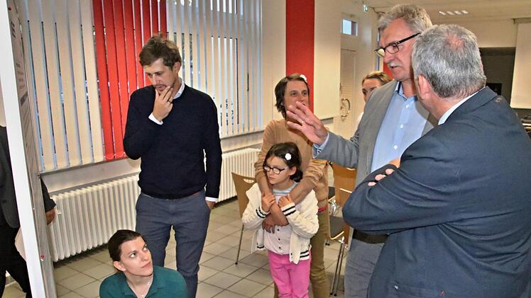 Annkatrin Nicklas (kniend) bringt die Ideen von (von rechts) Bürgermeister Jürgen Hennemann, Ebern, Bürgermeister Helmut Dietz, Untermerzbach und weiteren Besuchern auf Papier.  Foto: Helmut Will