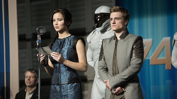 Katniss (Jennifer Lawrence) und Peeta (Josh Hutcherson) sollen eigentlich gute Stimmung in allen Distrikten verbreiten. Doch die Anspannung bei Panems Bewohnern wird immer st&auml;rker.