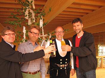 Auf gutes Gelingen des Neubaus der freien evangelischen Gemeinschaft stoßen beim Richtfest an (von links): Klaus Hampel vom Bauausschuss der Gemeinde, Pastor Werner Kröger, Zimmermeister Ulrich Wiemer und Matthias Stegner, Vorsitzender der Gemeinschaft. Foto: Martin Koch