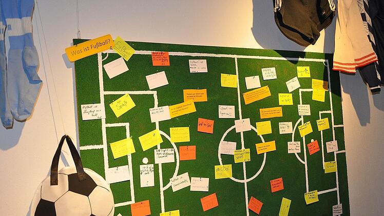 Auf einer Pinnwand schreiben die Ausstellungsbesucher, was Fußball für sie bedeutet.