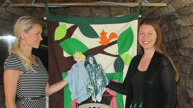 Die Autorin und Spielerin Carolin Sell (r.) und Maria Sturzebacher (l.) präsentieren die Darsteller des Theaterstücks, Saalea und Mühlengeist Johann. Foto: Winfried Ehling
