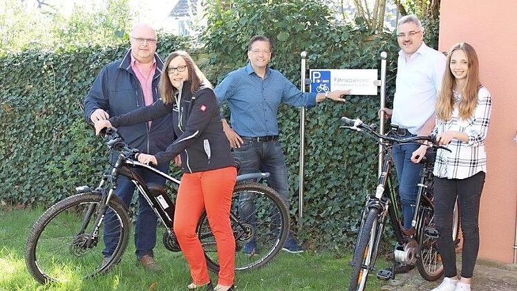 Bürgermeister Karsten Fischkal (Mitte) mit Mitarbeitern vor der neuen Fahrradladestation am Rathaus Foto: pr