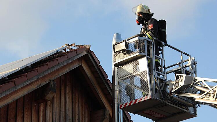 Ein Feuerwehrmann im Einsatz am Dach.