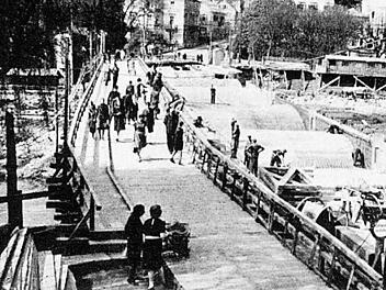 Gesprengt wurde am 6. April 1945 die Ludwigsbrücke in Bad Kissingen. Anschließend von den Amerikanern wieder aufgebaut. Ein Holzsteg (links im Bild) diente der Bevölkerung als Provisorium. Foto: Story of Spa, 1946