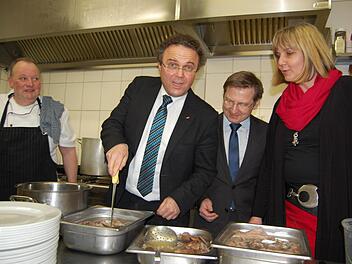 Hans-Peter Friedrich prüft schon mal, ob das Fleisch durch ist. Mit im Bild: Gastwirt Axel Fink (links), Coburgs CSU-Chefin Birgit Weber sowie Mathias Zimmer, Vorsitzender des CSU-Ortsvereins Coburg-Ost. Foto: Oliver Schmidt