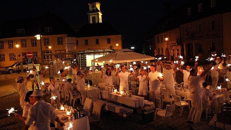 Stimmungsvoller Abschluss: Mit Wunderkerzen verabschiedeten sich die Teilnehmer am ersten "Diner en blanc" auf dem Stadtsteinacher Marktplatz. Foto: Tobias Schöffel