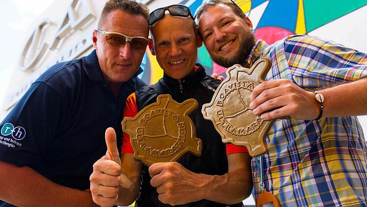 Markus Süße (links) mit Julian Popp (rechts) und dem Sieger über 150 Kilometer, Ivan Zufferli, die jeweils die Finishermedaille in Form einer Schildkröte erhielten. Foto: Markus Süße