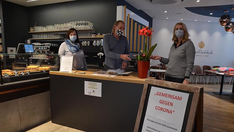 Gaby Richter und ihr Bruder Jürgen Rattmann starten heute ihre zweite Gutscheinaktion. Der Tisch steht im Café "Handgebäck", links die Geschäftsleiterin Elena Frühwald. Fotos: Bernhard Panzer