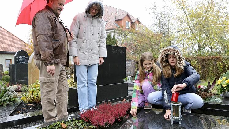 Clemens, Ute, Annika und Isabel Raab am Grab von Opa Josef auf dem Burgebracher Friedhof. Foto: Barbara Herbst