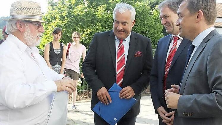 Ein Musiker (links) der englischen Toothill Bigband hieß Kultusminister Ludwig Spaenle (M.) in Wallenfels willkommen. Zuvor hatte die Bigband aus der Wallenfelser Partnerstadt Bingham den Minister musikalisch begrüßt. Rechts neben Spaenle verfolgten CSU-Landratskandidat Klaus Löffler und Wallenfels' Bürgermeister Jens Korn die Szene. Foto: Veronika Schadeck