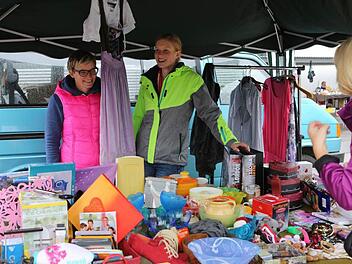 Stefanie Schrüfer (l.) und ihre Freundin haben für den verregneten Trödeltag immerhin ein Lächeln übrig. Fotos: Barbara Herbst