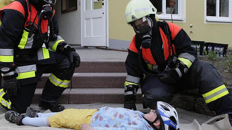 Der kleine Justus darf sich von zwei Helfern mit einem Rettungstuch bergen lassen.