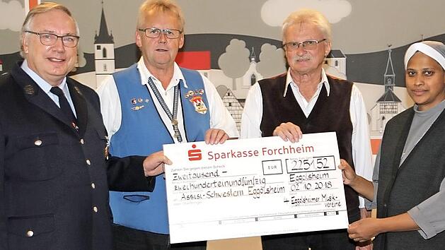 Schwester Mercitta nimmt den Scheck von den Leitern der Musikkapellen, Heinz Hanna (links)vom Musikzug der Freiwilligen Feuerwehr Neuses, Albin Giehl (2.v.r.) von der Eggerbachtaler Blaskapelle und Alfred Huber (2.v.l.) vom Musik- und Gesangverein Unterstürmig, entgegen.  Foto: Erlwein