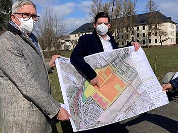 Ob Dominik Sauerteig und Regiomed-Chef Alexander Schmidtke (links) stellen erste Planungen vor. Orange sind die Klinik-, pink die Wohngebäude.